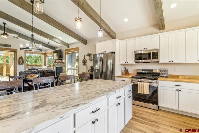 a kitchen with stainless steel appliances granite countertop a stove and a sink