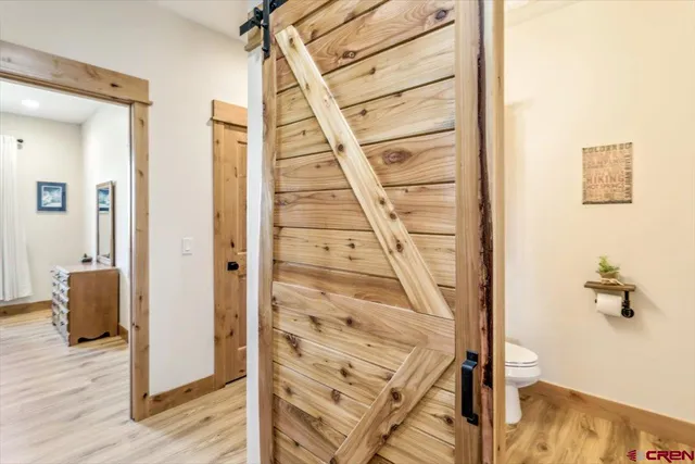 a bedroom with a bed and a painting on the wall