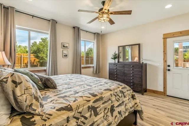 a bedroom with a large bed and a chandelier