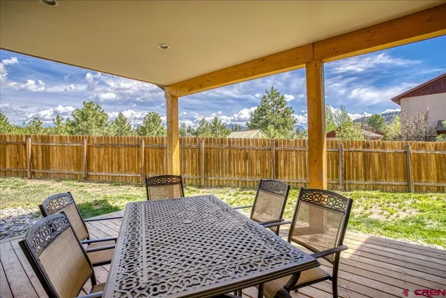 a view of a patio with table and chairs and wooden floor