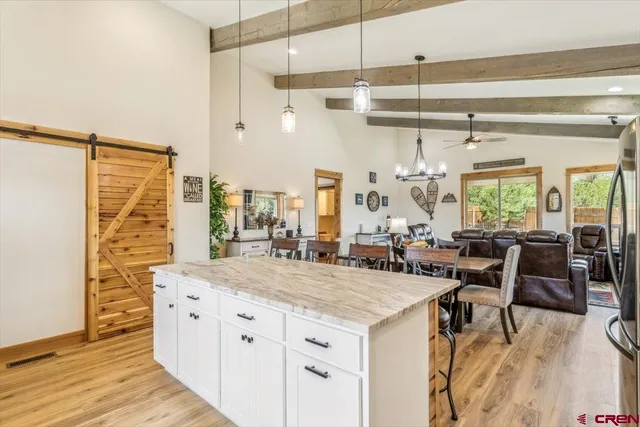 a large kitchen with kitchen island a large counter space a sink appliances and dining table view
