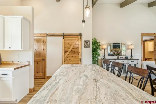 a bedroom with a bed and a view of living room