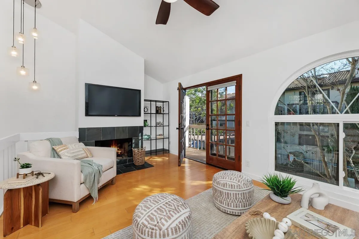 2364 Altisma Way, Unit B Carlsbad, CA 92009 - Photo 1 of 26 a living room with furniture and a flat screen tv