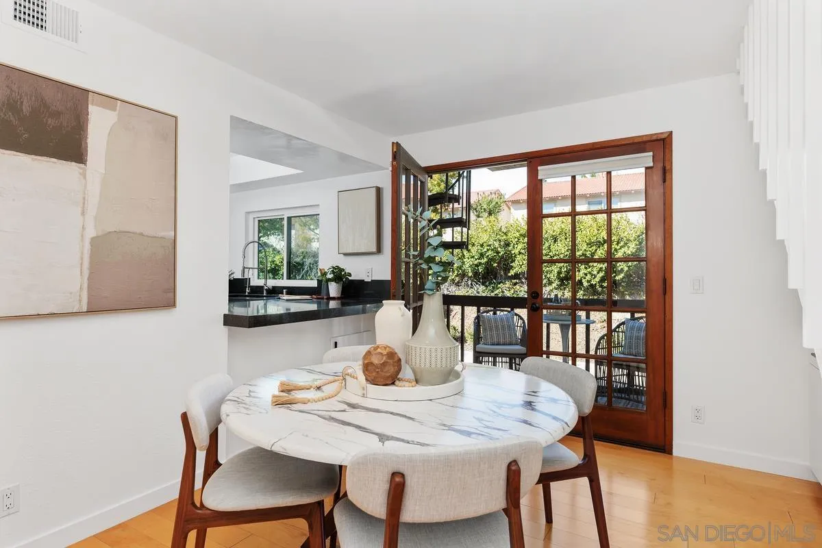 2364 Altisma Way, Unit B Carlsbad, CA 92009 - Photo 14 of 26 a dining room with furniture and wooden floor