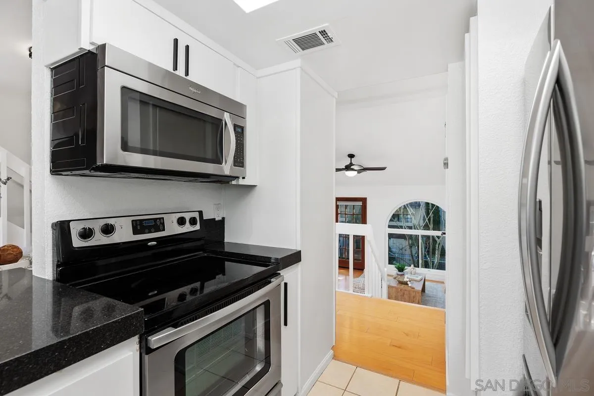 2364 Altisma Way, Unit B Carlsbad, CA 92009 - Photo 16 of 26 a kitchen with a stove and a microwave