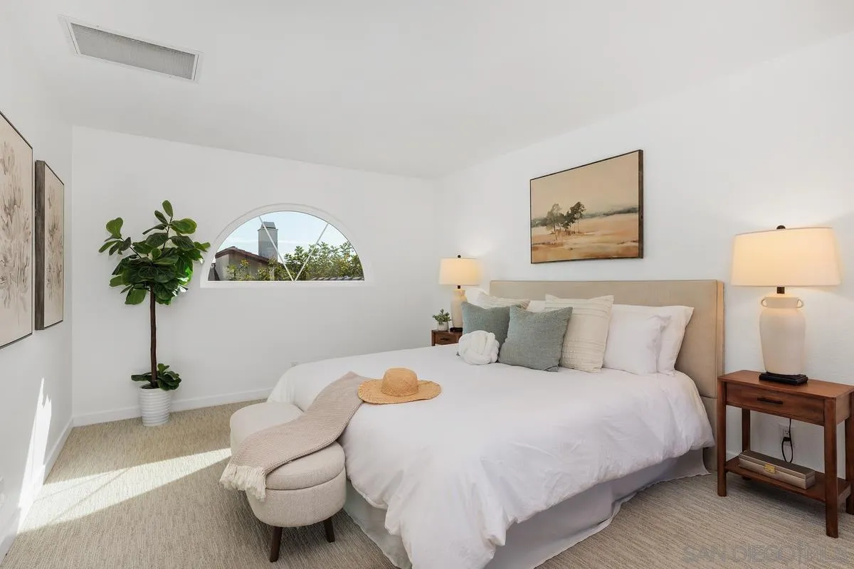 2364 Altisma Way, Unit B Carlsbad, CA 92009 - Photo 18 of 26 a bedroom with a bed and a potted plant