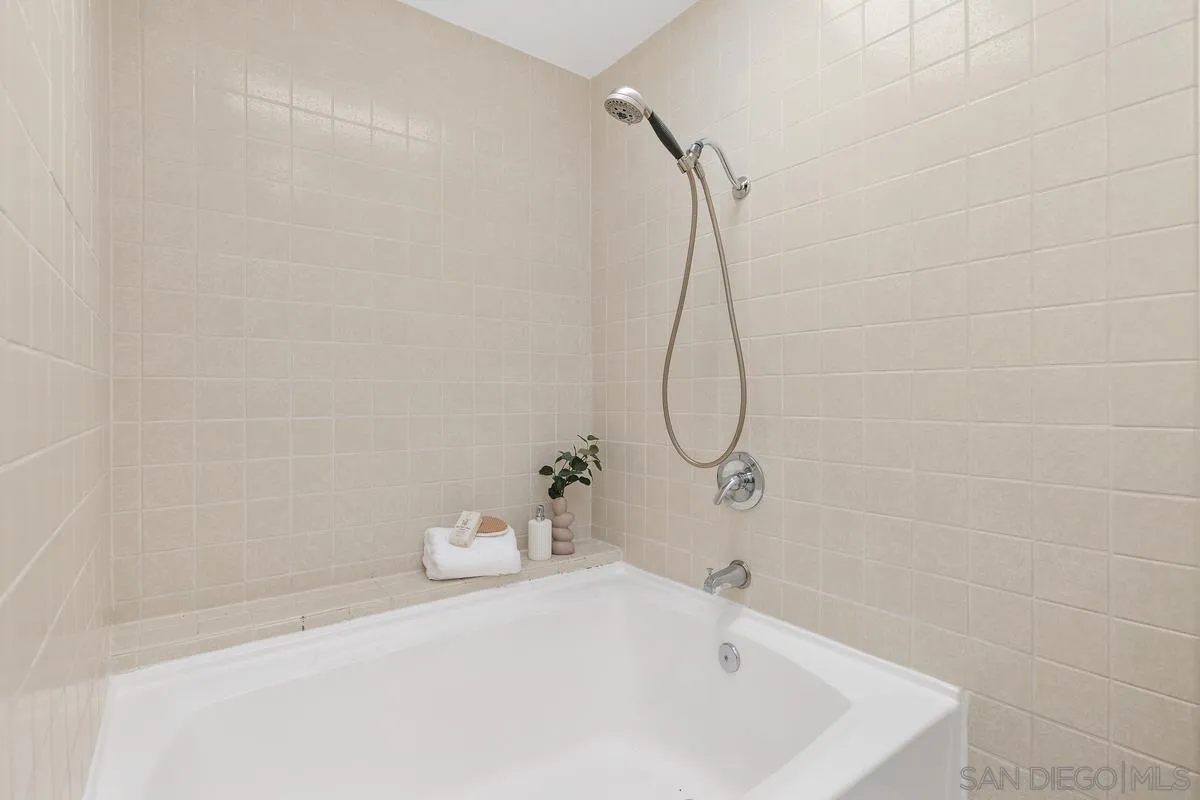 2364 Altisma Way, Unit B Carlsbad, CA 92009 - Photo 21 of 26 a bathroom with a bath tub with a shower