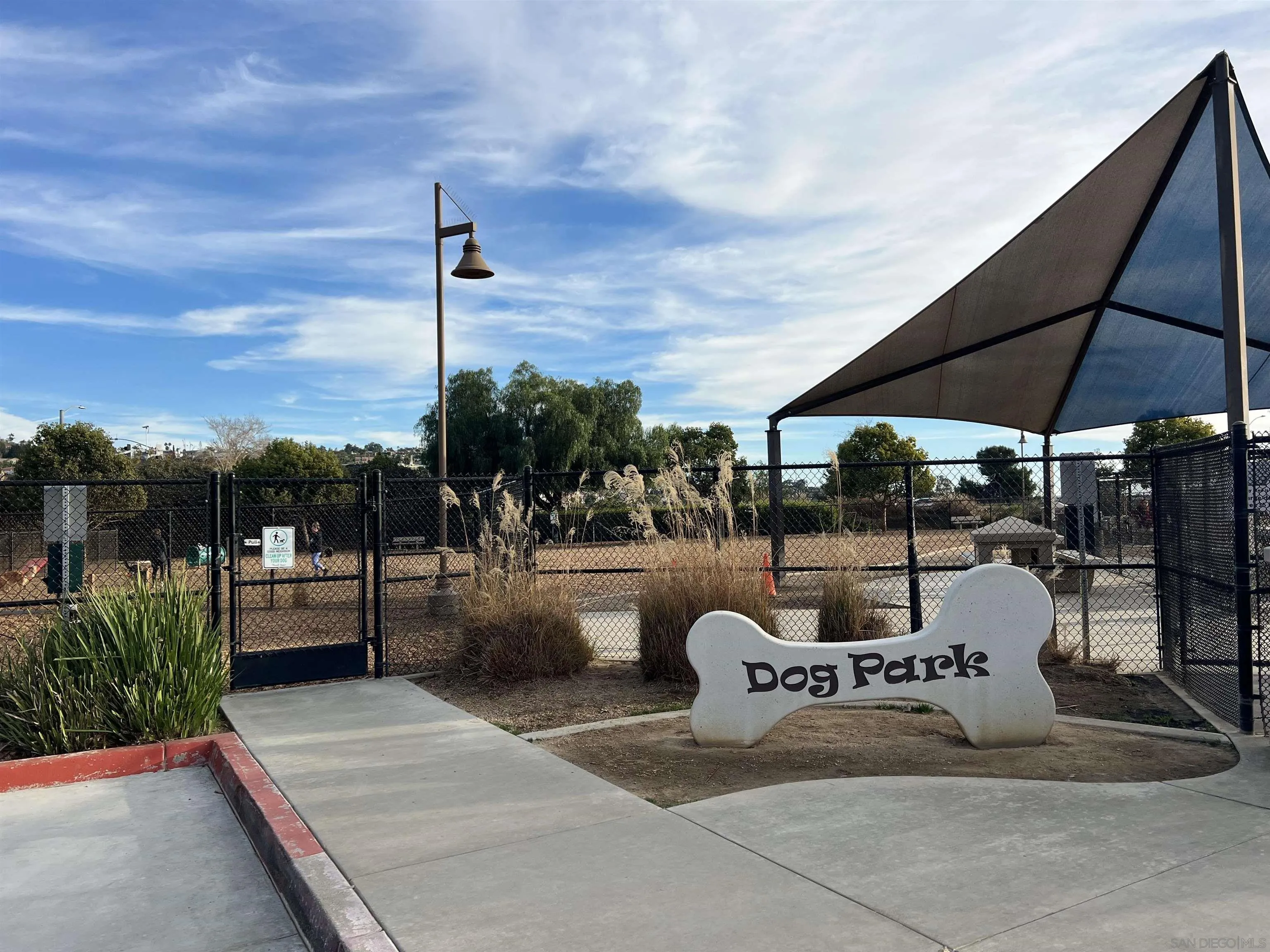2364 Altisma Way, Unit B Carlsbad, CA 92009 - Photo 25 of 26 a view of a patio with a table and chairs under an umbrella
