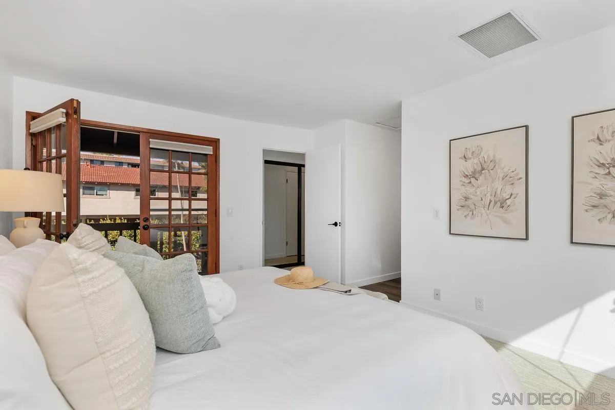 2364 Altisma Way, Unit B Carlsbad, CA 92009 - Photo 4 of 26 a bedroom with a large bed and a window