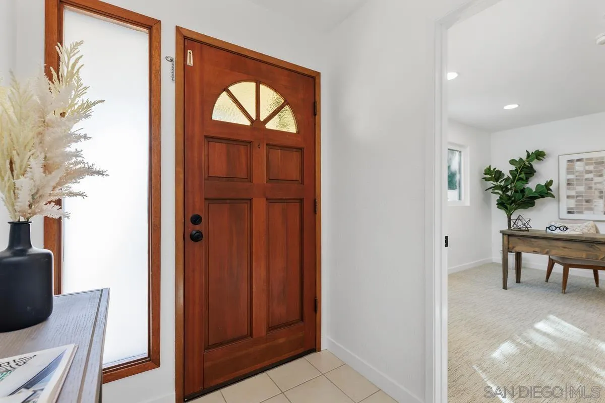 2364 Altisma Way, Unit B Carlsbad, CA 92009 - Photo 6 of 26 a view of dining room and livingroom with furniture wooden floor cabinet and mirror
