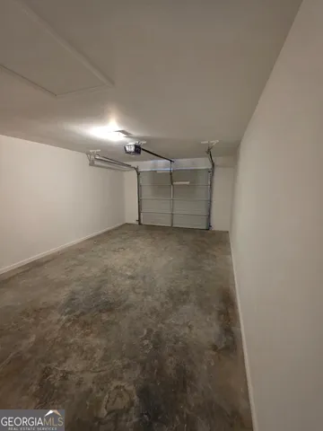 an empty room with wooden floor and window