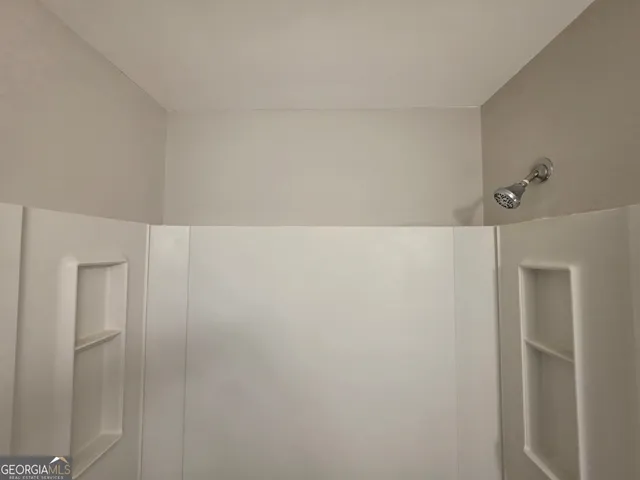a view of a hallway with wooden floor and closet