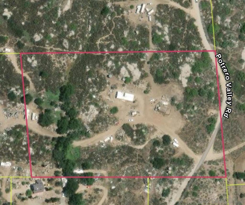 1446 Boulder Oaks Road Potrero, CA 91963 - Photo 2 of 3 a street sign that is sitting in a backyard