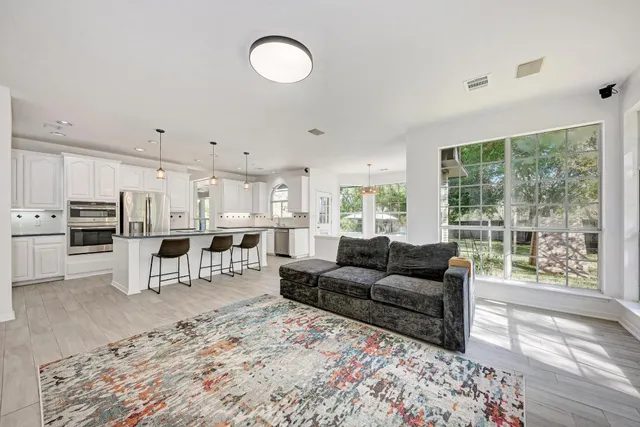 a living room with furniture and a large window