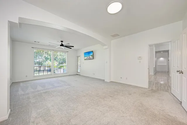 an empty room with windows and entrance