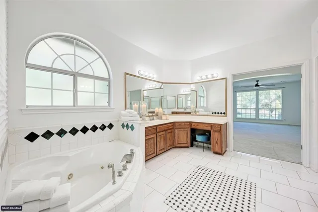 a bathroom with a bathtub sink and mirror