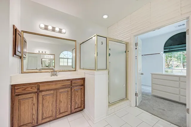 a bathroom with a sink a large mirror and a bathtub