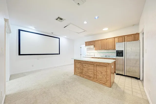 a kitchen with granite countertop white cabinets and stainless steel appliances