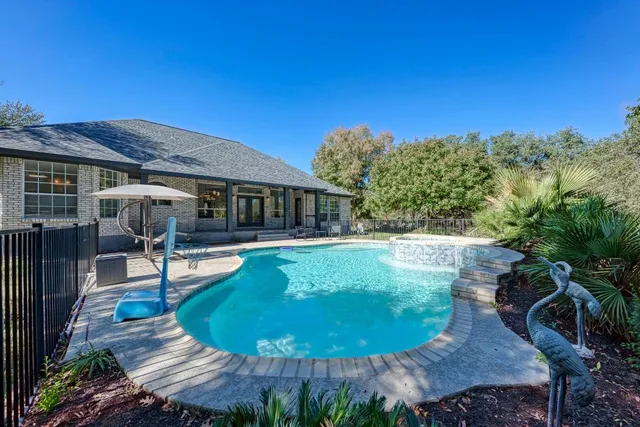 a view of a house with pool backyard and sitting area