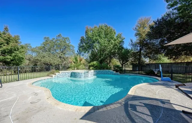 a view of a backyard with swimming pool