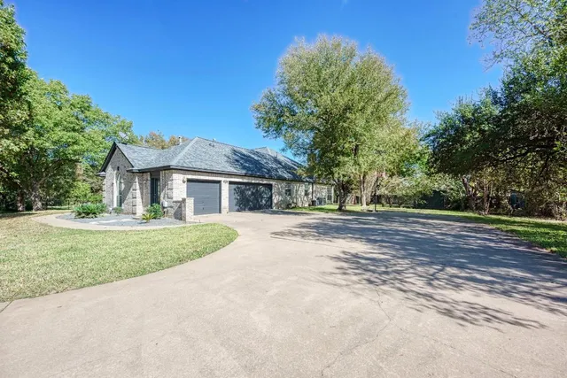 a front view of house with yard and trees