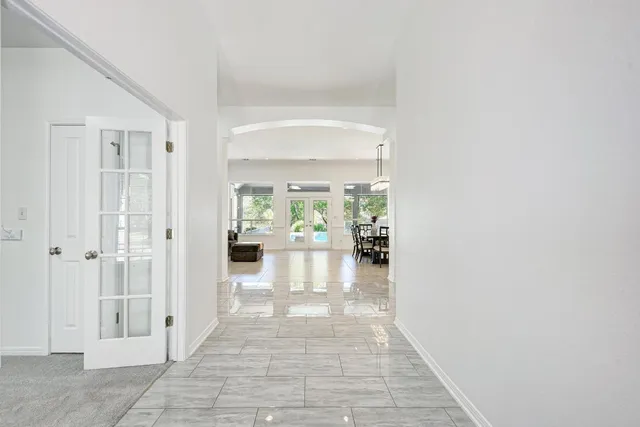 a hallway with a dining table and chairs