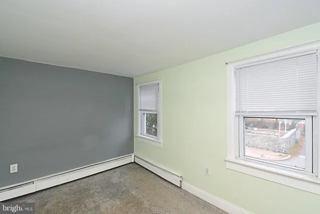 a bathroom with a sink toilet and window