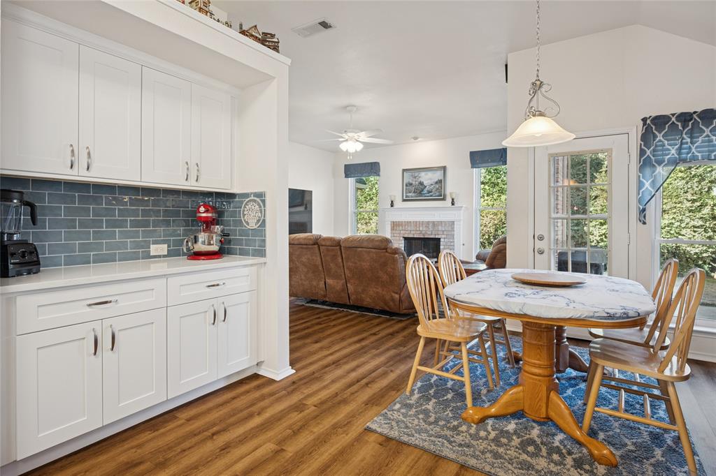5501 Mt McKinley Road Fort Worth, TX 76137 - Photo 11 of 26 a kitchen with stainless steel appliances granite countertop a table chairs and a refrigerator
