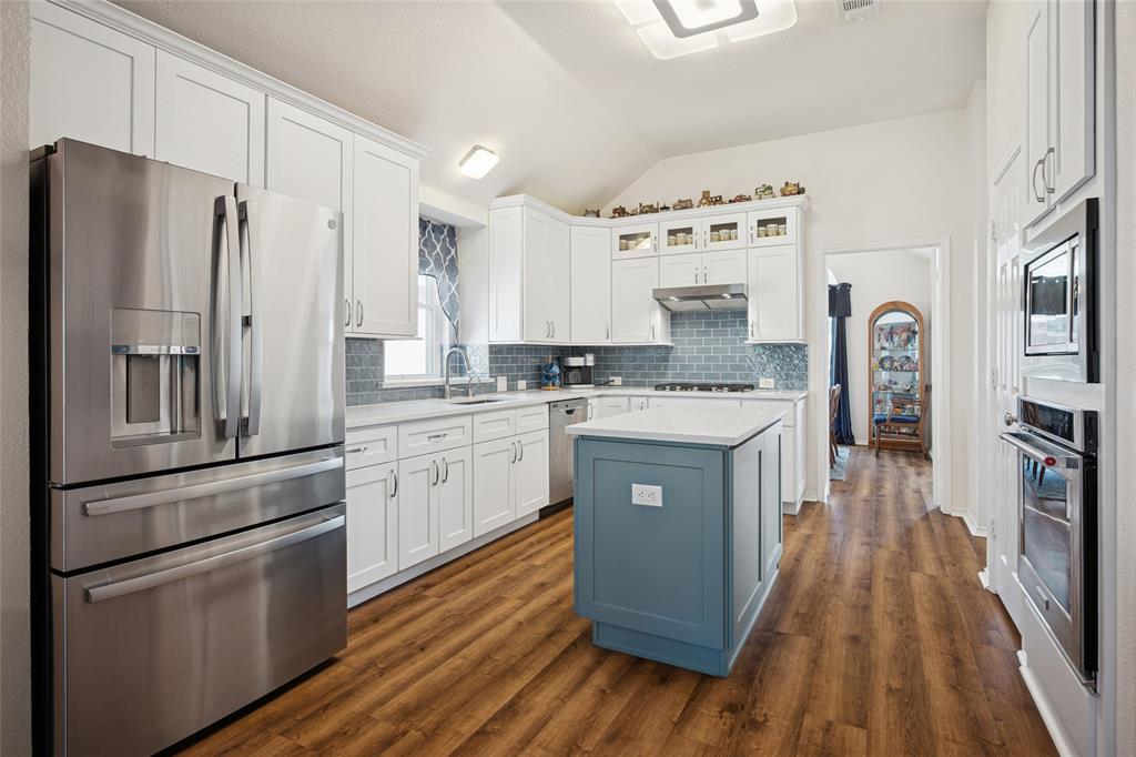 5501 Mt McKinley Road Fort Worth, TX 76137 - Photo 12 of 26 a kitchen with stainless steel appliances a refrigerator sink and cabinets