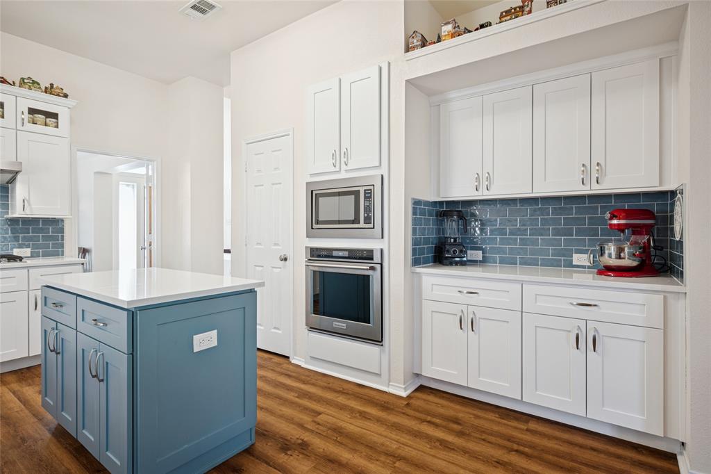 5501 Mt McKinley Road Fort Worth, TX 76137 - Photo 13 of 26 a kitchen with white cabinets and white appliances