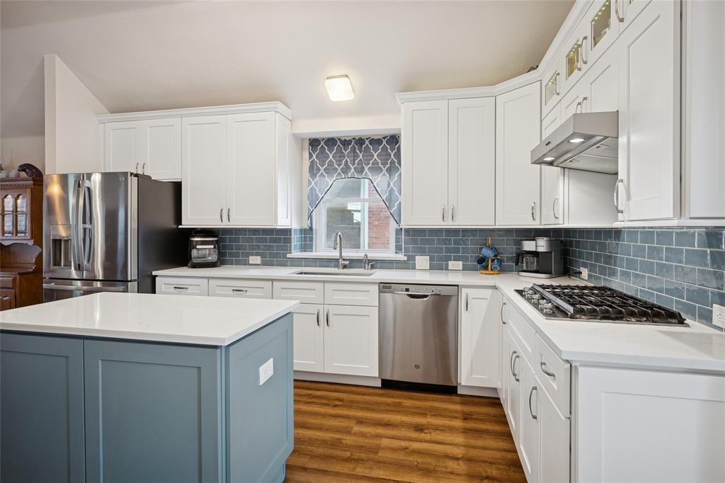 5501 Mt McKinley Road Fort Worth, TX 76137 - Photo 15 of 26 a kitchen with stainless steel appliances granite countertop a sink stove refrigerator and cabinets