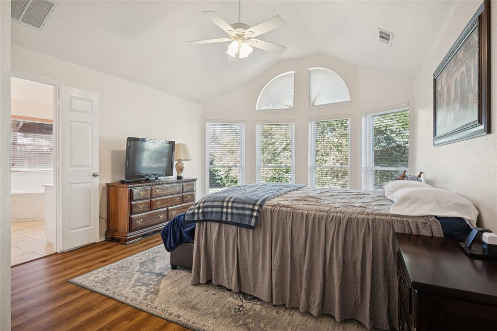 5501 Mt McKinley Road Fort Worth, TX 76137 - Photo 16 of 26 a bedroom with a bed and a flat screen tv