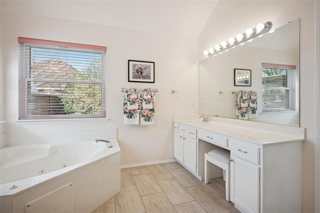 5501 Mt McKinley Road Fort Worth, TX 76137 - Photo 18 of 26 a spacious bathroom with a bathtub a sink and a window