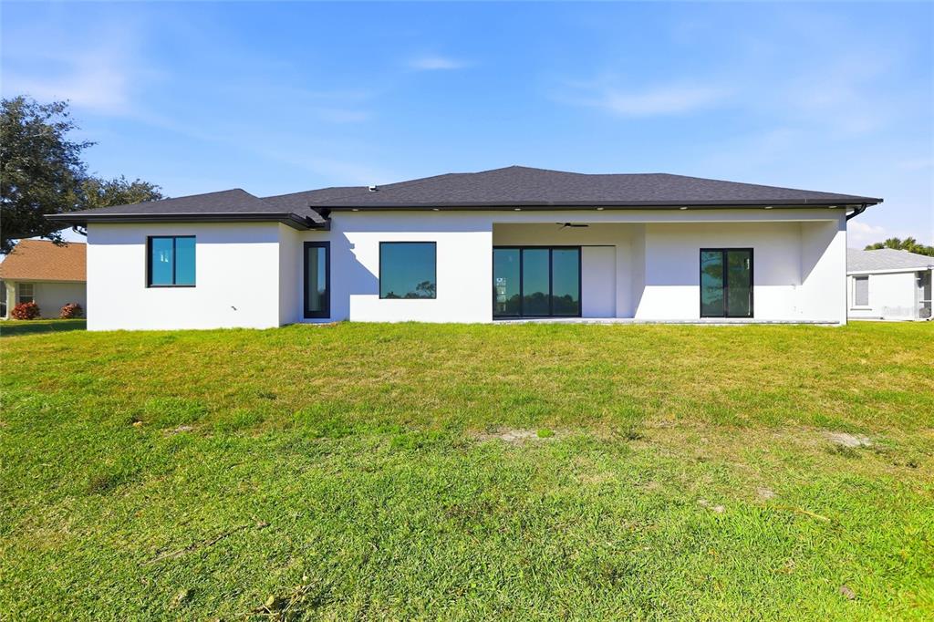 17 Long Meadow Road Rotonda West, FL 33947 - Photo 29 of 37 a front view of a house with a yard and garage