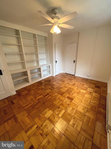 a bedroom with furniture and a large window