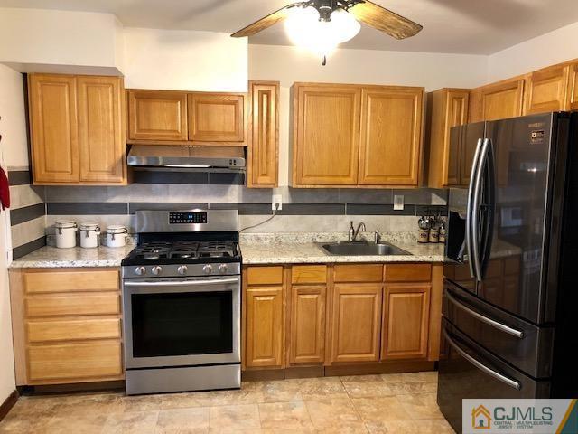 12 Atlantic Road Somerset, NJ 08873 - Photo 22 of 36 a kitchen with stainless steel appliances granite countertop a stove a refrigerator and a sink