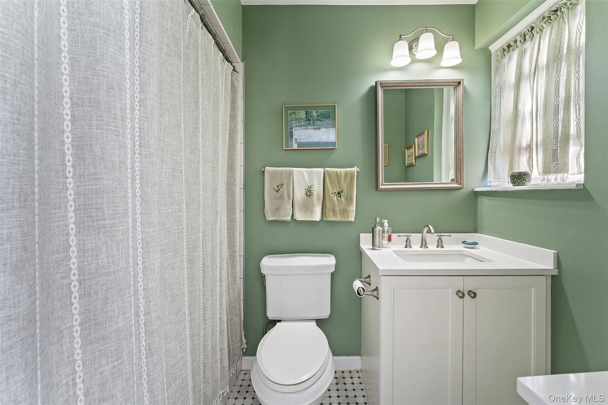 42 Pondfield Road West, Unit 6D Bronxville, NY 10708 - Photo 11 of 15 a bathroom with a toilet a sink and a mirror