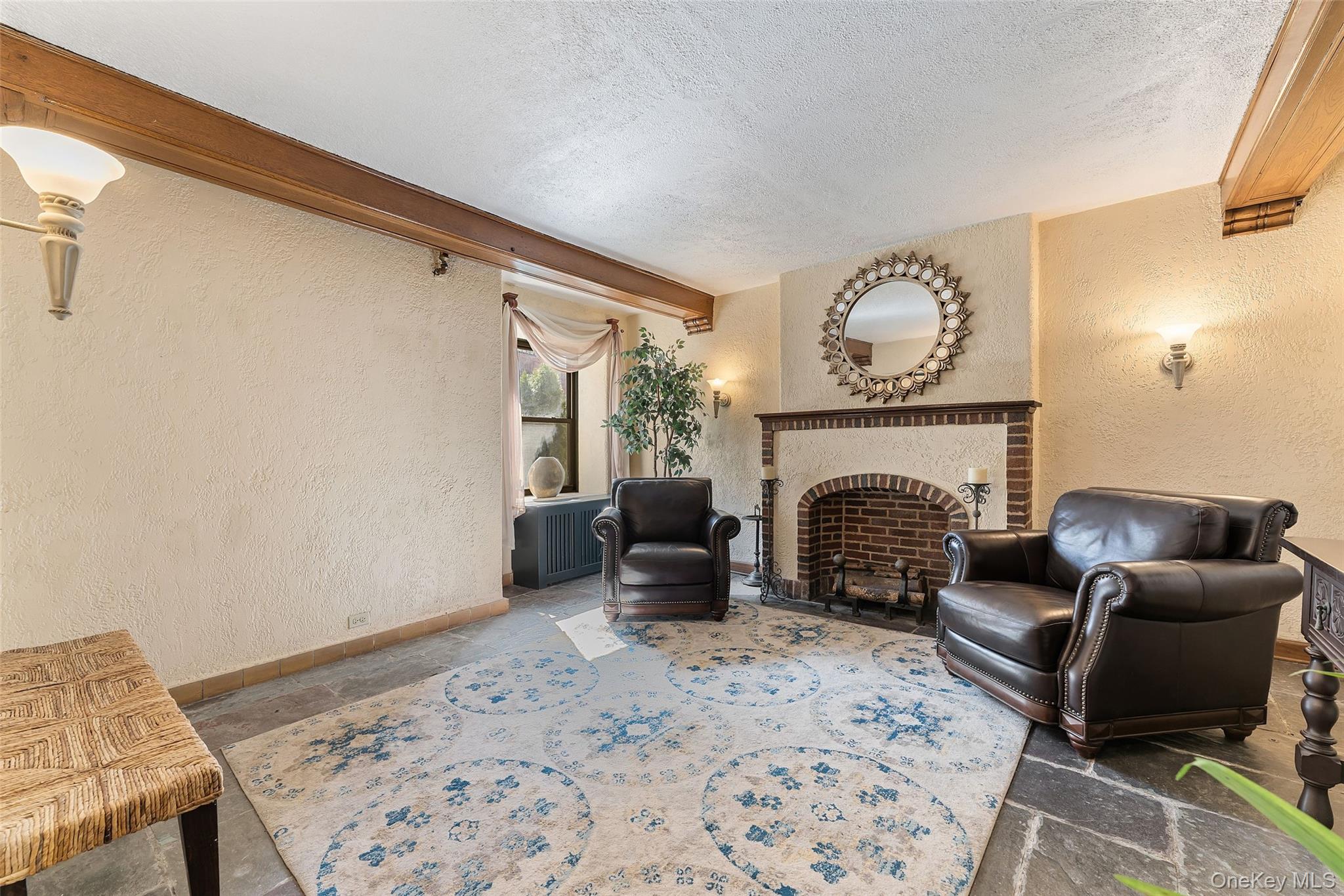 42 Pondfield Road West, Unit 6D Bronxville, NY 10708 - Photo 12 of 15 a living room with furniture and a fireplace