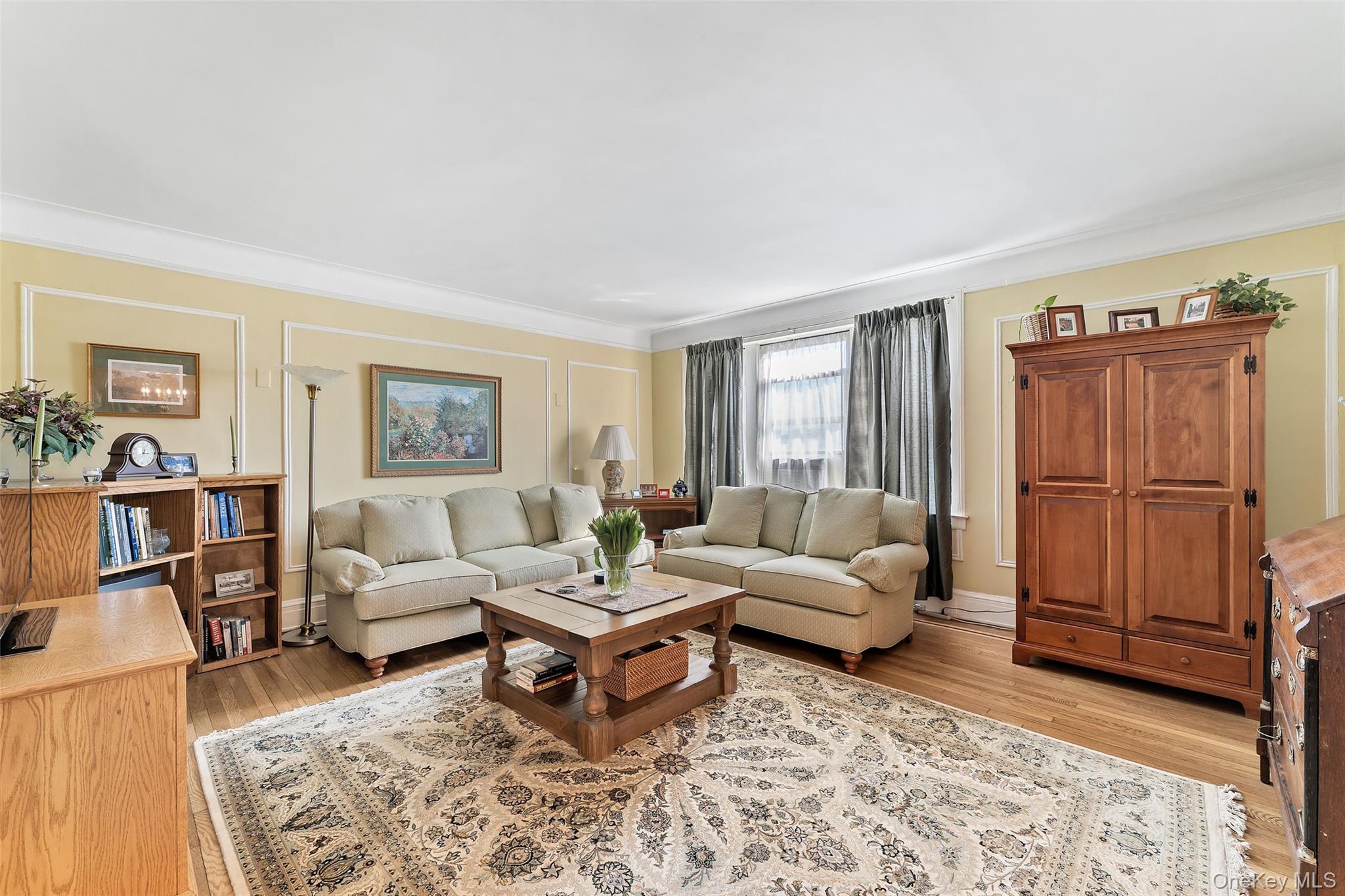 42 Pondfield Road West, Unit 6D Bronxville, NY 10708 - Photo 3 of 15 a living room with furniture and a rug