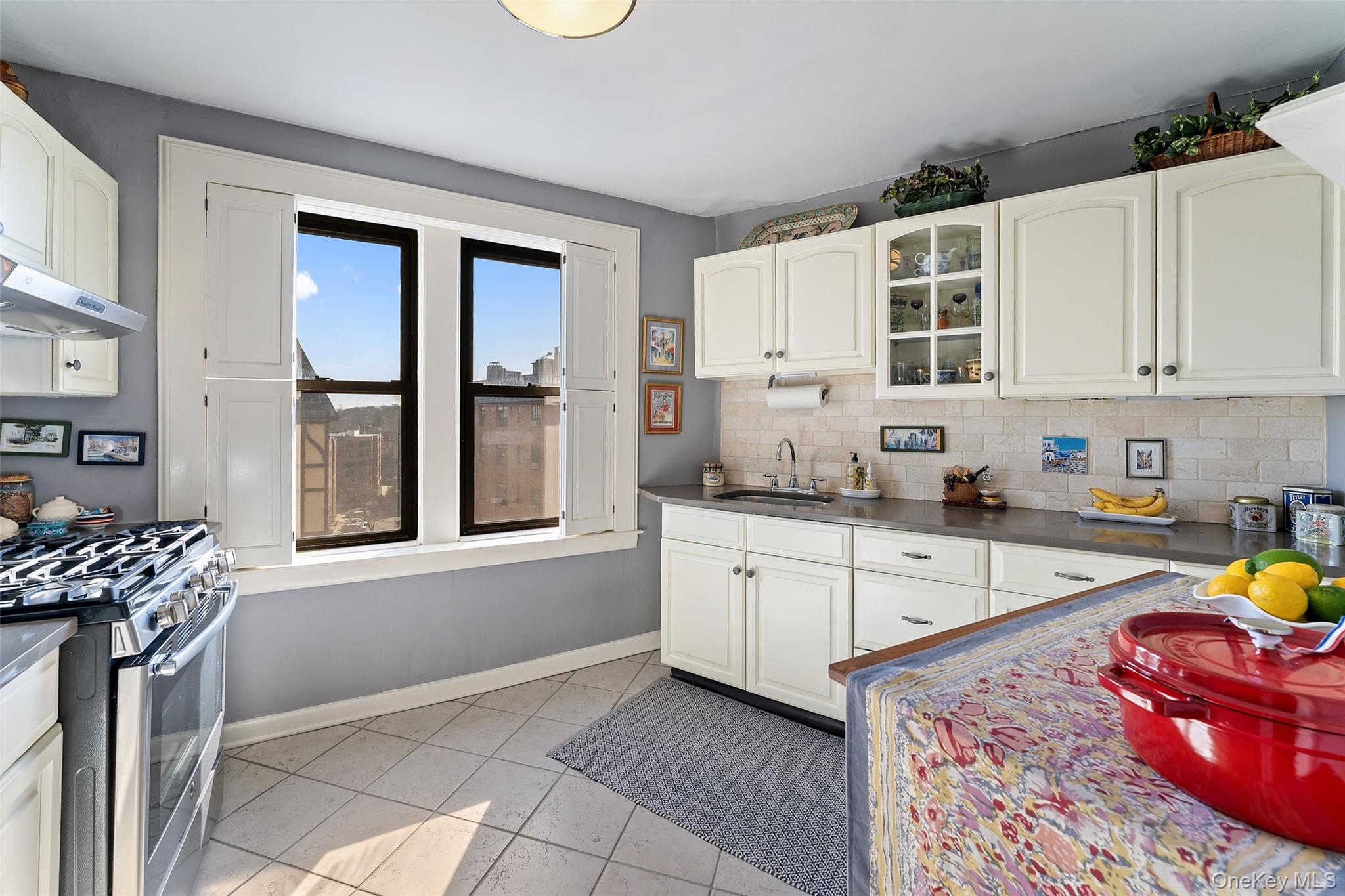 42 Pondfield Road West, Unit 6D Bronxville, NY 10708 - Photo 6 of 15 a kitchen with stainless steel appliances granite countertop a stove a sink and a microwave