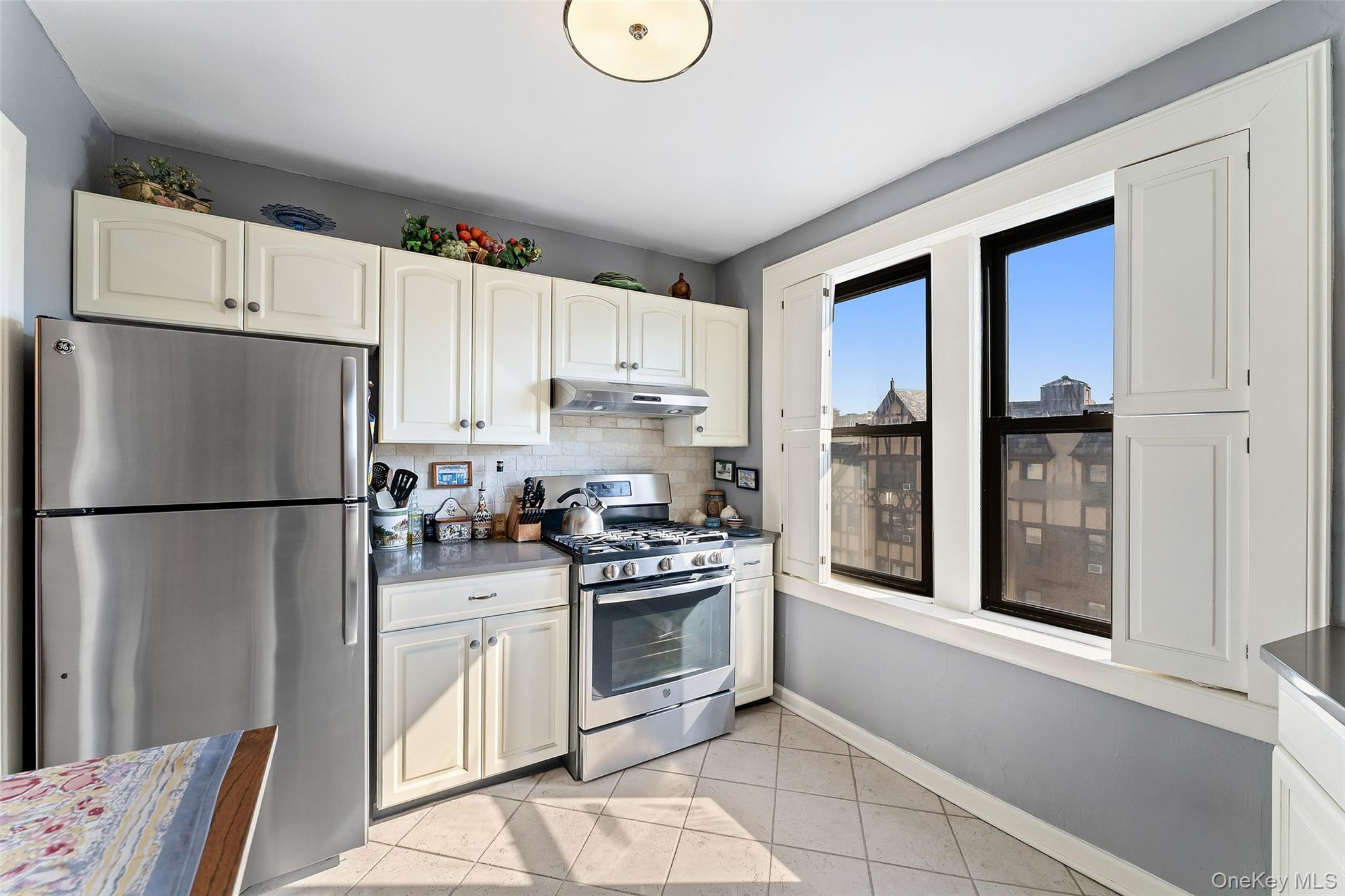 42 Pondfield Road West, Unit 6D Bronxville, NY 10708 - Photo 7 of 15 a kitchen with stainless steel appliances granite countertop a refrigerator sink and stove