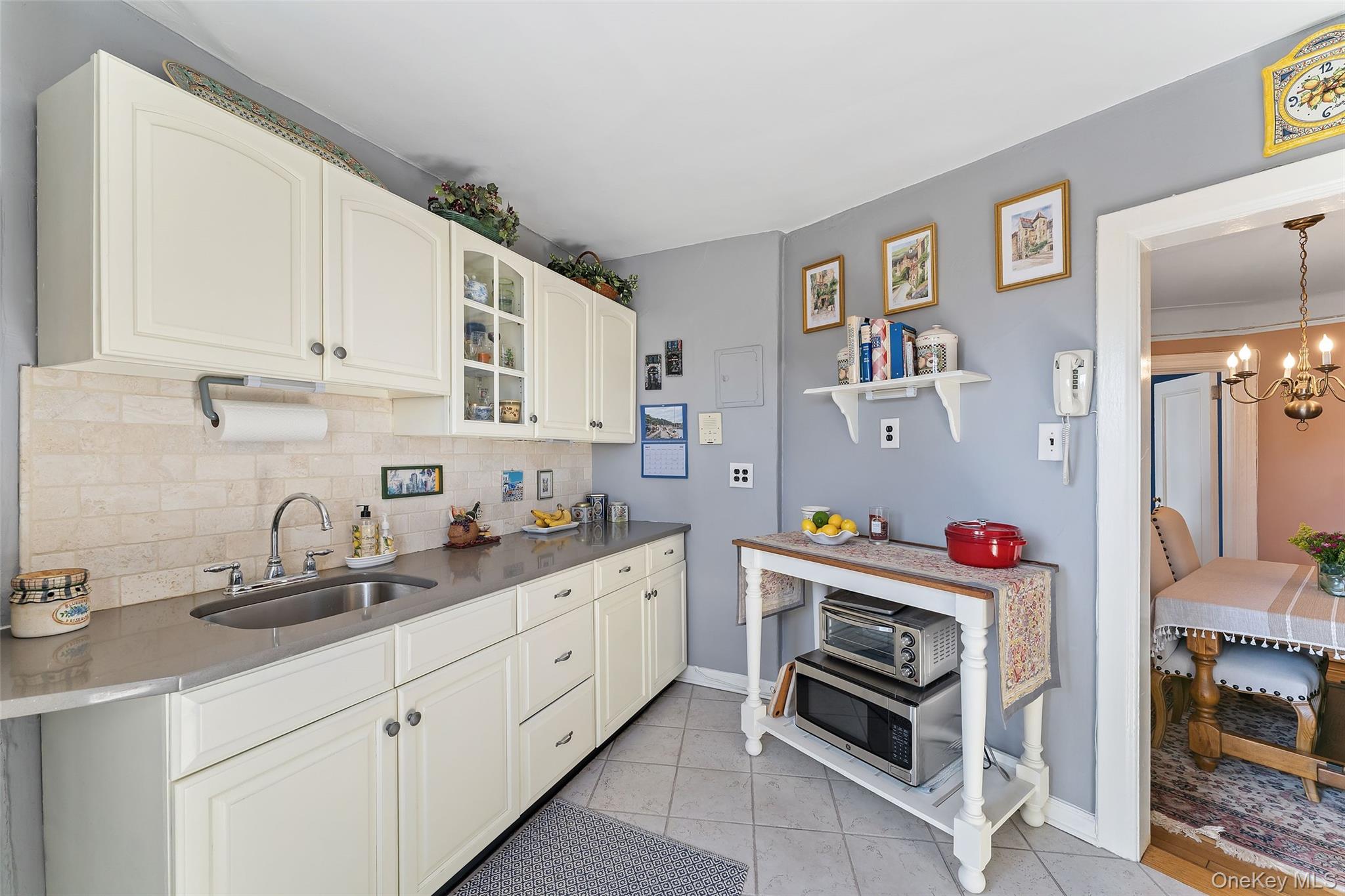 42 Pondfield Road West, Unit 6D Bronxville, NY 10708 - Photo 8 of 15 a kitchen with stainless steel appliances a stove a sink and a refrigerator