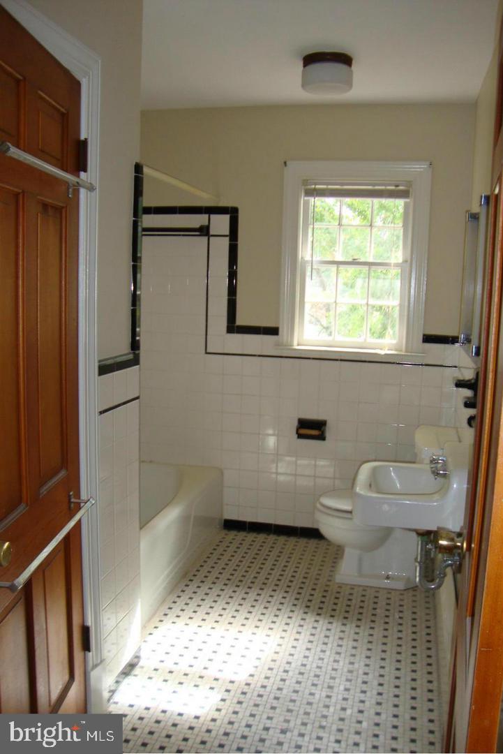 1408 Parcell Street Fredericksburg, VA 22401 - Photo 11 of 12 a bathroom with a sink a toilet and shower