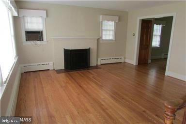 1408 Parcell Street Fredericksburg, VA 22401 - Photo 2 of 12 a view of an empty room with wooden floor and a window
