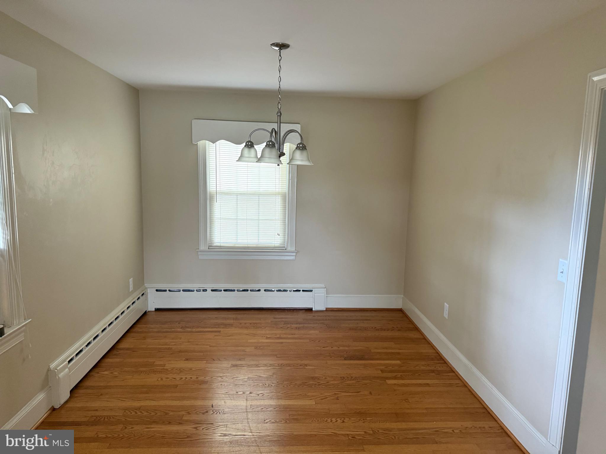 1408 Parcell Street Fredericksburg, VA 22401 - Photo 4 of 12 wooden floor in an empty room with a window