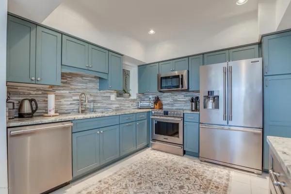 a kitchen with a refrigerator sink and microwave