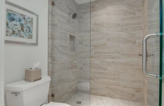 a bathroom with a toilet and a shower