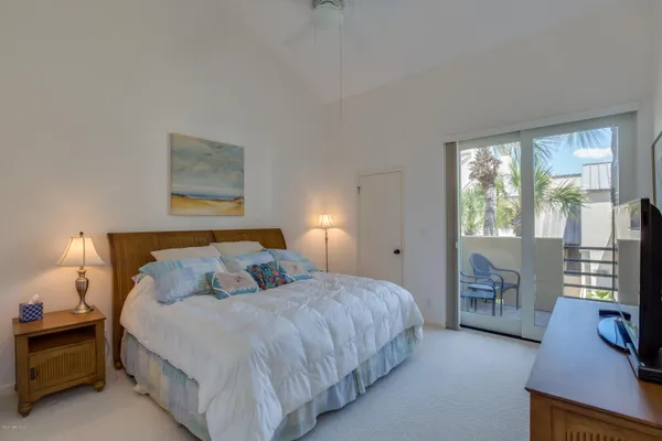 a bedroom with a bed and a tv