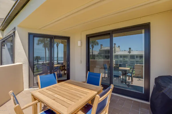 a view of a dining room with a table and chairs