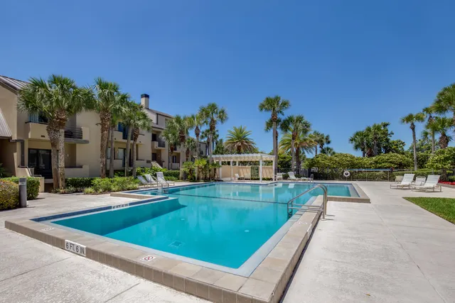 a view of a house with swimming pool and sitting area